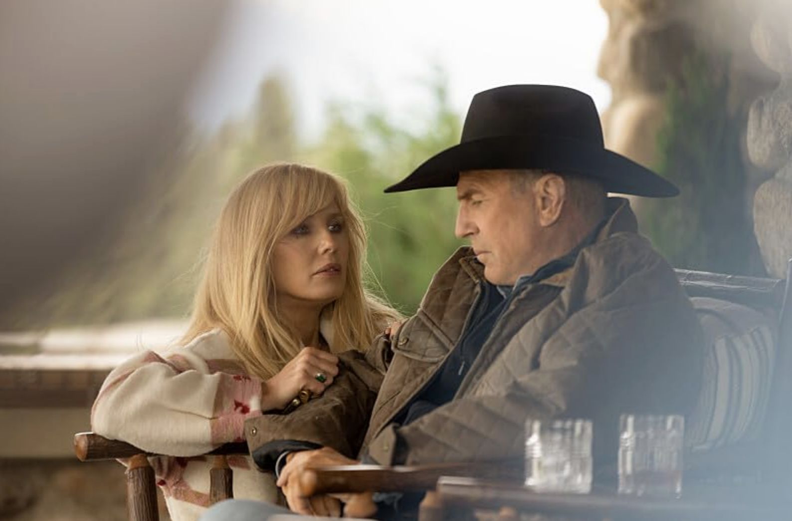 Kevin Costner (right) and Kelly Reilly (left) in a 2022 episode titled Watch &#039;Em Ride Away (Image via Paramount Network)