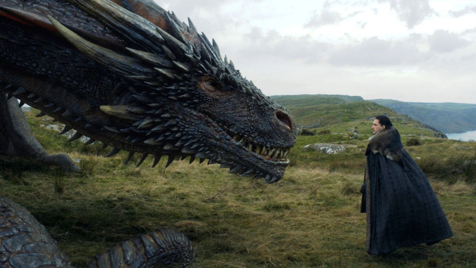 Jon Snow who has Targaryen blood alongside the dragon he tamed | Image via HBO