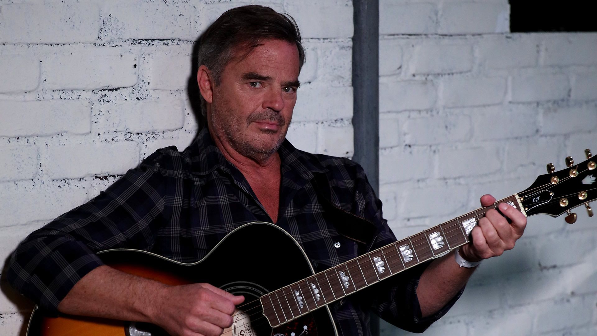 General Hospital&rsquo;s Wally Kurth posing with his guitar. | Image Source: ABC