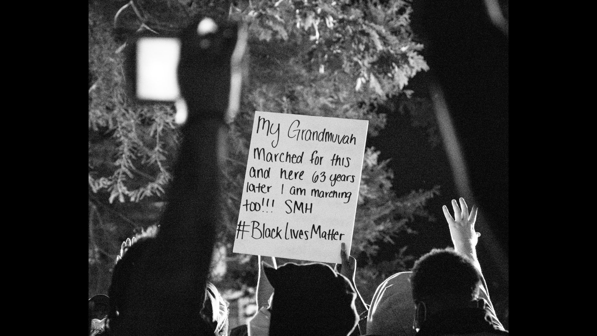 Representational image of people holding signage (Image via Unsplash/ koshuuu)