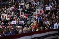 Donald Trump supporters hold Laken's posters during his campaign rally in Rome, GA (Image via Getty)