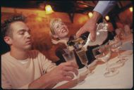 Couple Being Served Champagne at Elaine's (Image via Getty)