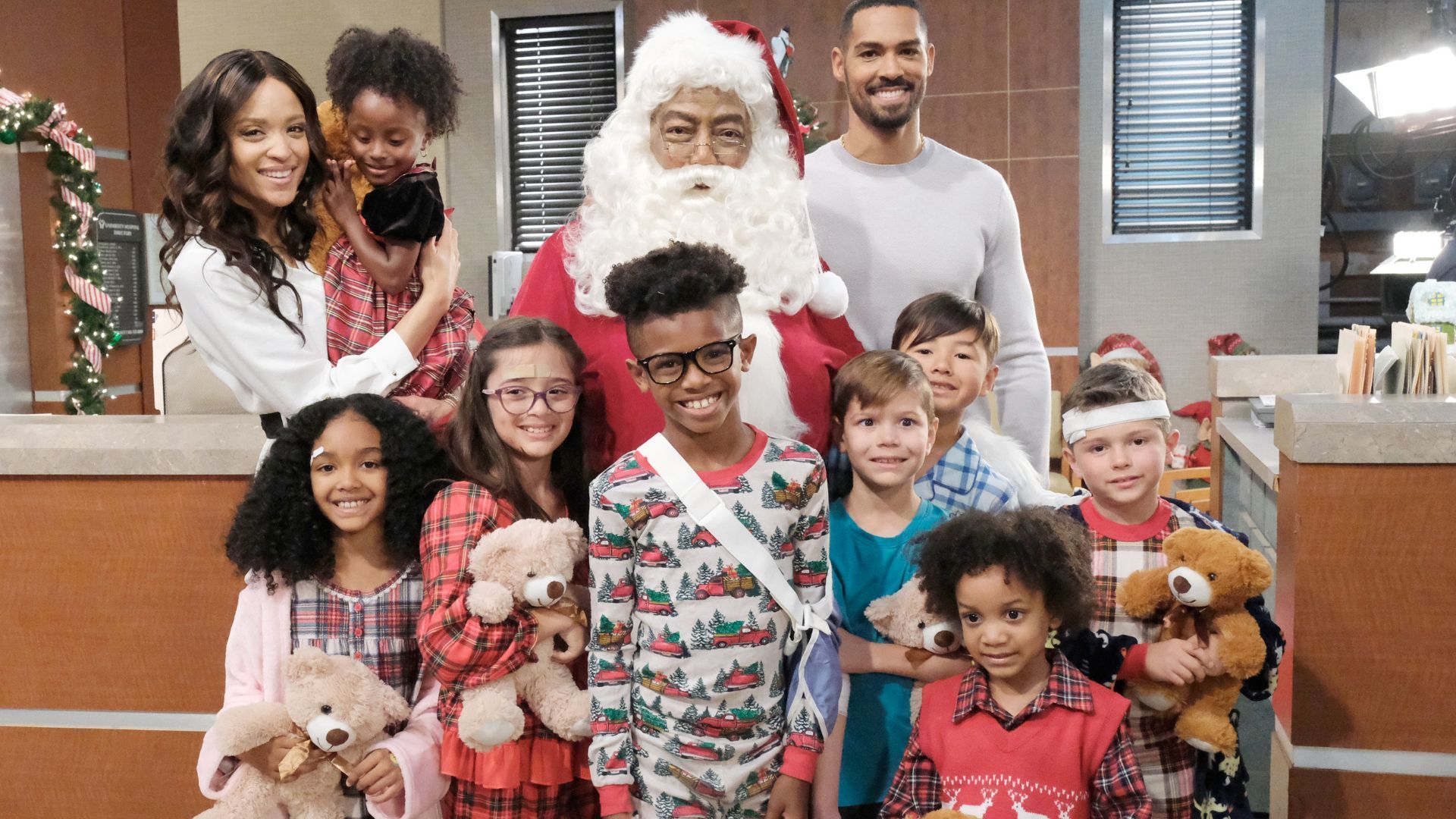 Sal Stowers as Lani, James Reynolds as Santa Abe, and Lamon Archey as Eli pose with the kids | Image Source: JPI Studios