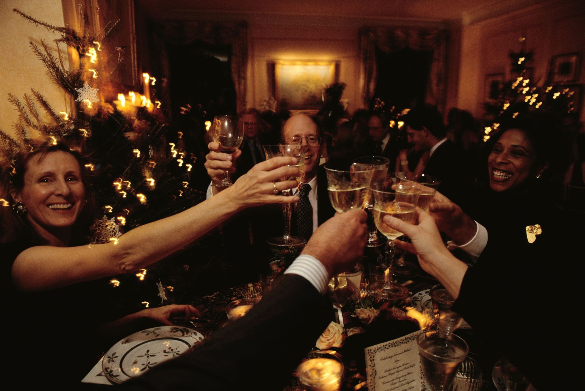 People Toasting at Christmas Party - Source: Getty