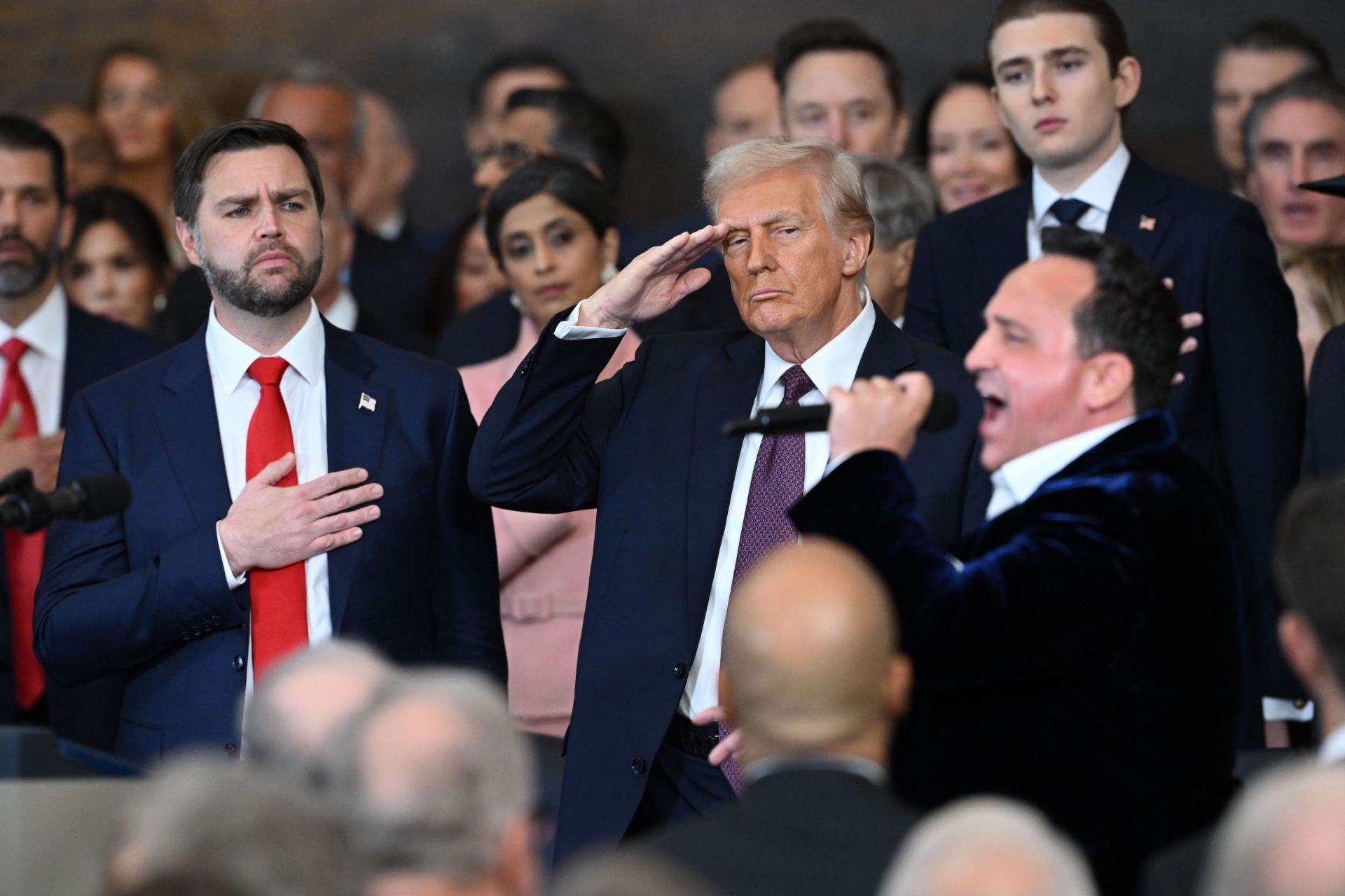 The 47th President salutes, as Macchio sings the national anthem (Image via Saul Loeb - Pool/Getty Images)