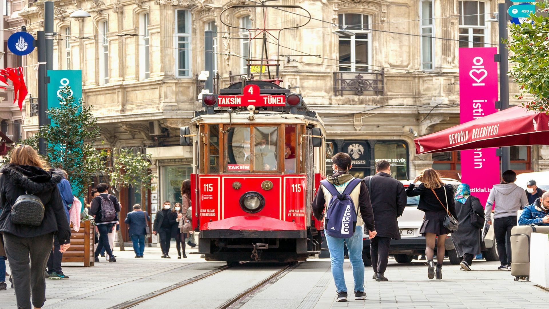 People walking on sidewalk near red tram during daytime (Image via Unsplash/@Maria Krasnova)