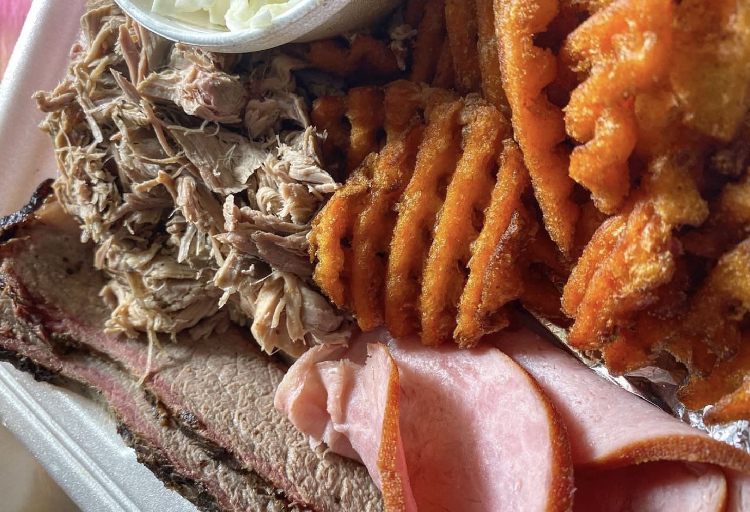 Sliced brisket, ham, pulled pork, sweet potato waffle fries, and coleslaw. (Image via Instagram/@its.lisanguyen)