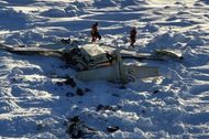 The wreckage of the Bering Air plane crash outside Nome, Alaska, while recovery workers attempt to remove the victims and evaluate the damage in the face of severe winter circumstances. At the isolated crash scene, authorities brave severe weather and shaky ice floes as they continue their investigations. (Image via X/@ohyeslawd)