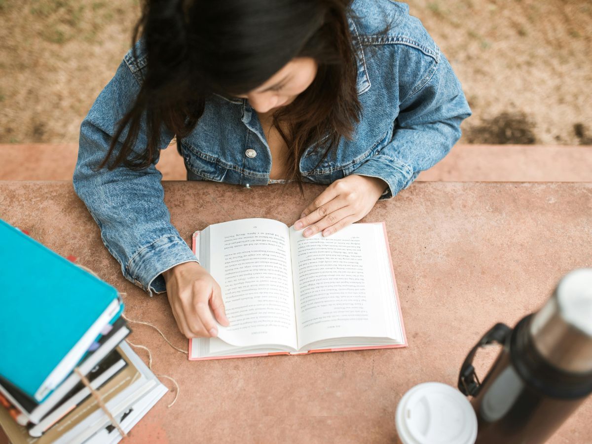 Reading a book (Image via Pexels)