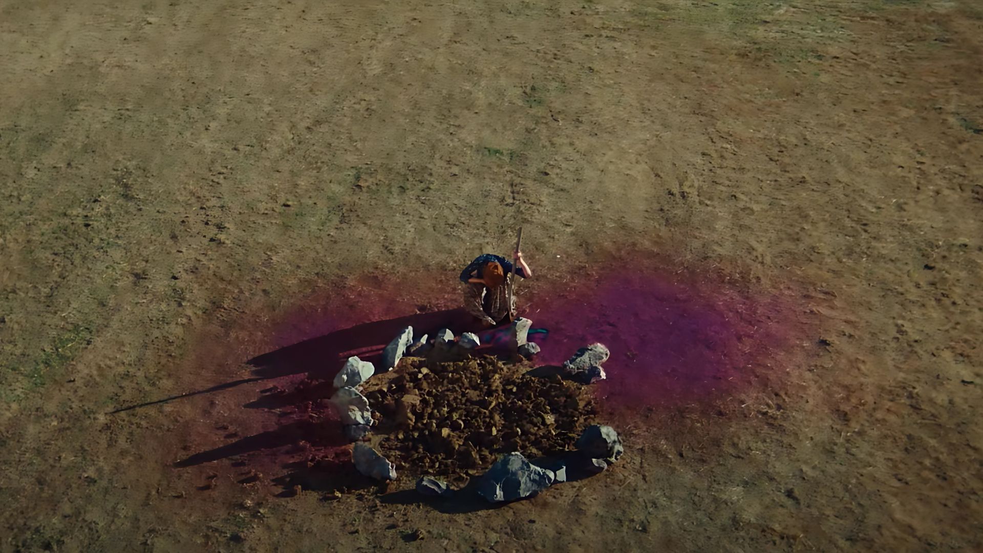 A girl sitting in a barren land