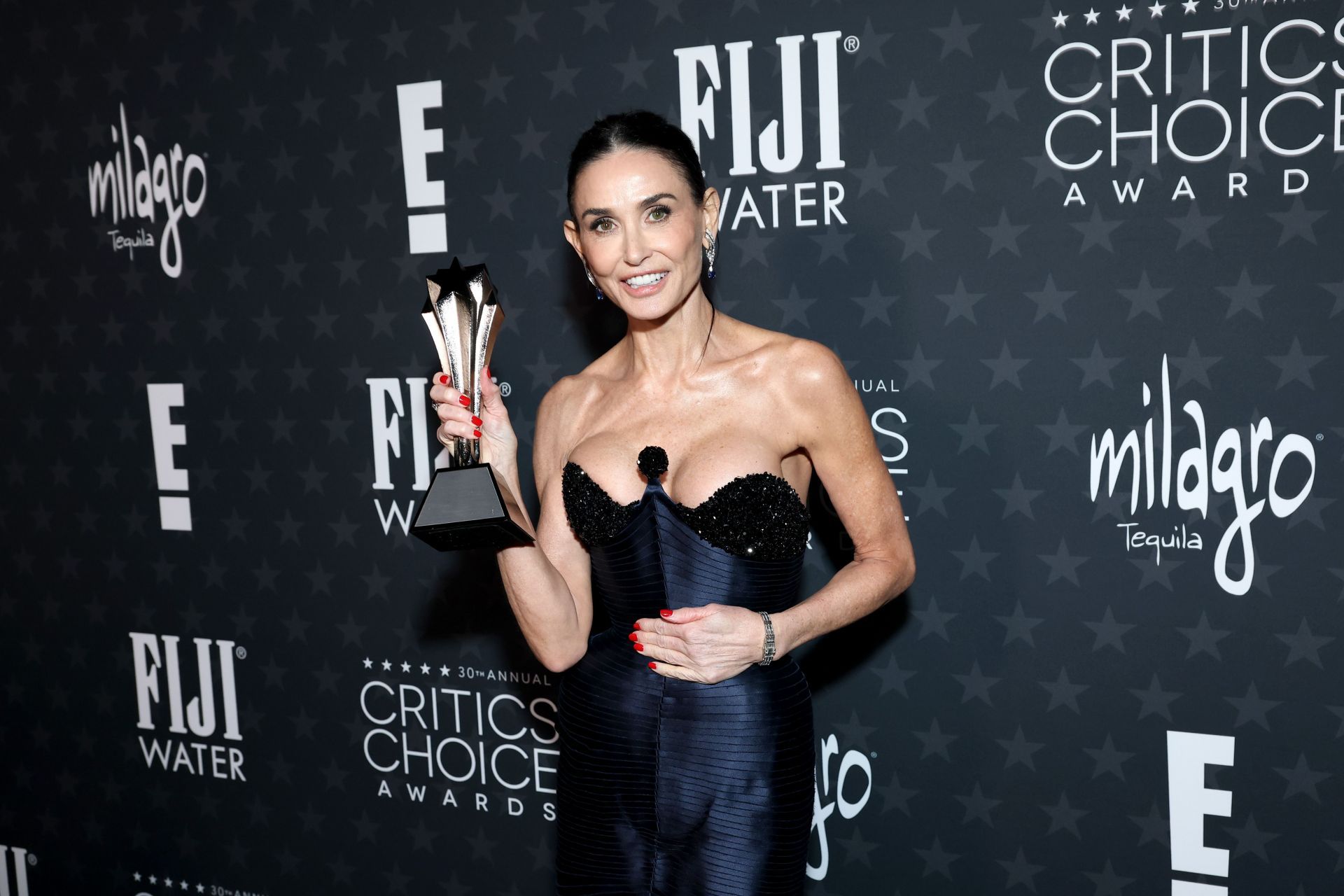 Demi Moore poses backstage during the 30th Annual Critics Choice Awards. (Image via Getty)