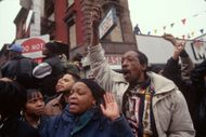People watch Biggie's funeral procession in the neighbourhood where he grew up. (Image via Getty)