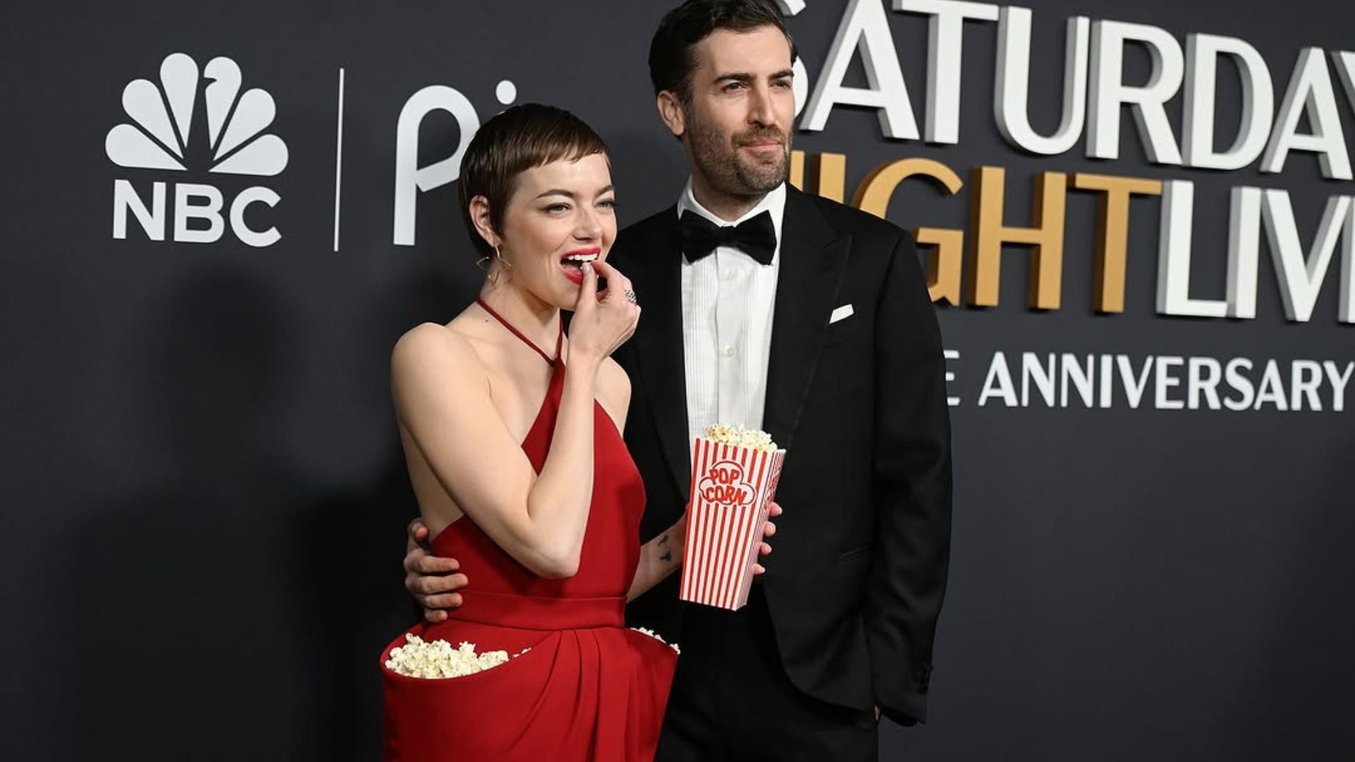 Emma Stone looked radiant in a red halter-necked dress with popcorn in the pockets (Image via Instagram/@nbc)