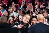 Robert Pattinson reacts with fans as he attends the "Mickey 17" premiere during the 75th Berlinale International Film Festival Berlin (Source: Getty)