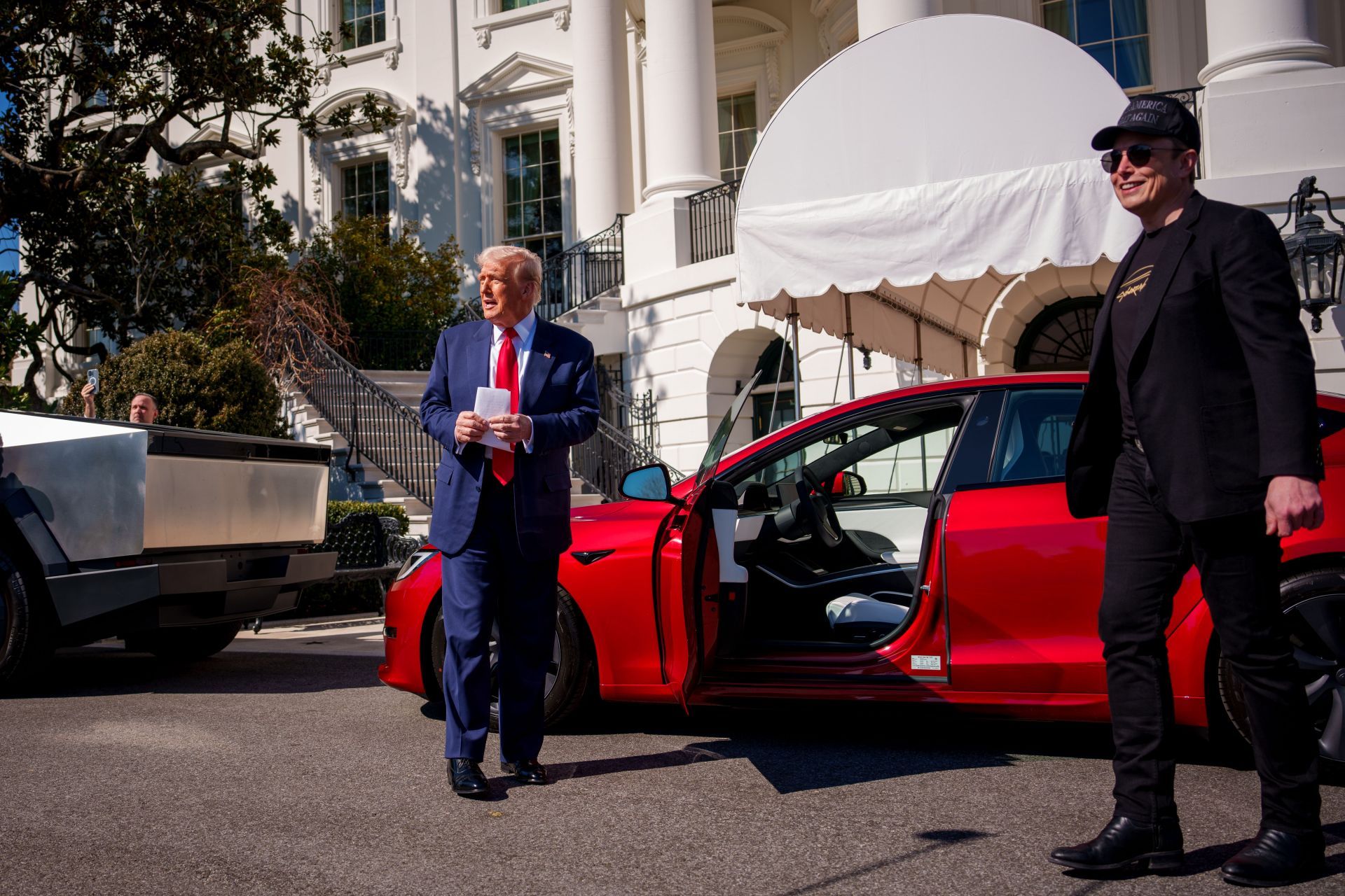 President Trump buys Tesla (Image via Getty)