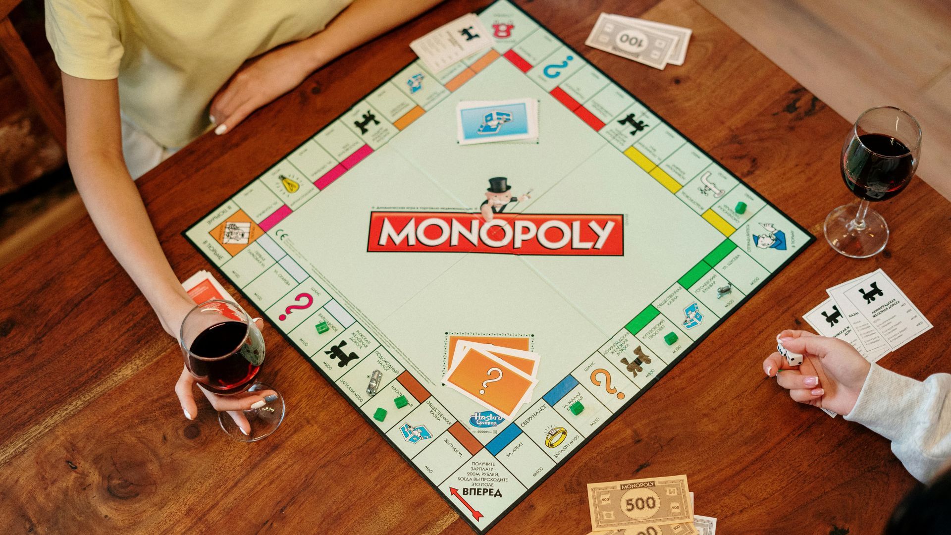 Monopoly Board Game on Brown Wooden Table