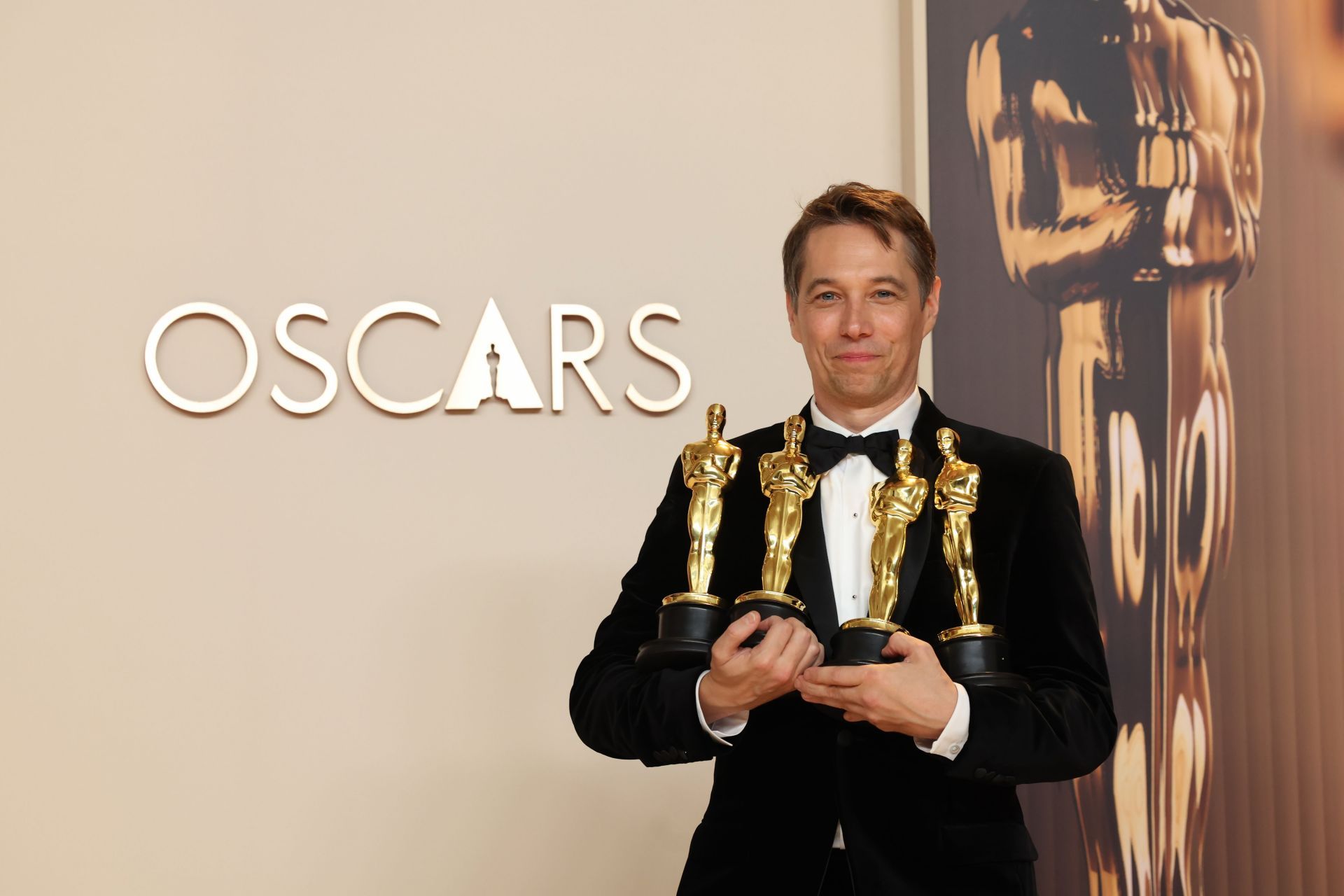 Baker with his four Oscar statuettes that he won at the 97th Academy Awards (Image via Jason Armond/Getty Images)