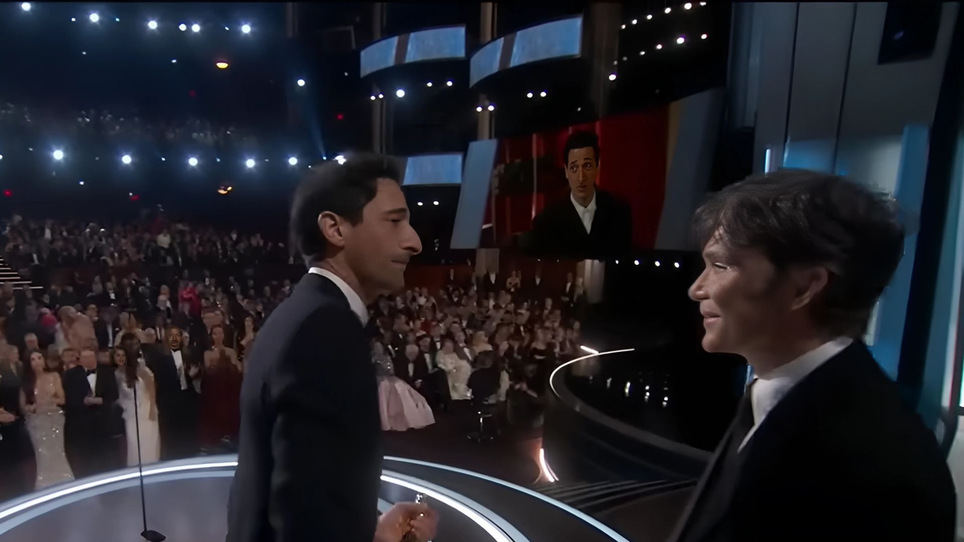 Adrien Brody accepts the Oscar from Cillian Murphy