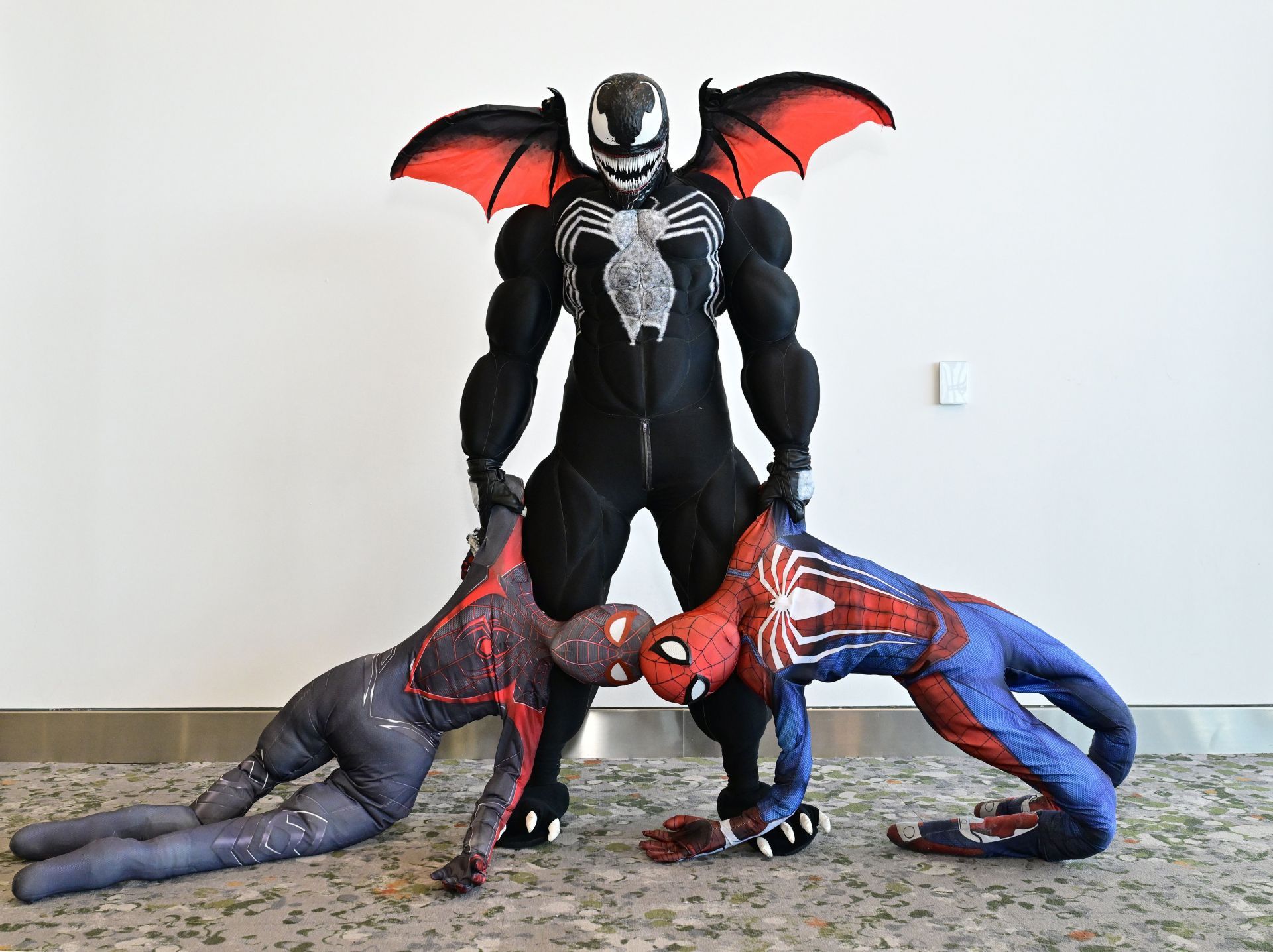 Cosplayers pose as Miles Morales, Venom and Spider-Man during at The Jacob K. Javits Convention Center on October 19, 2024 in New York City. (Image via Getty)