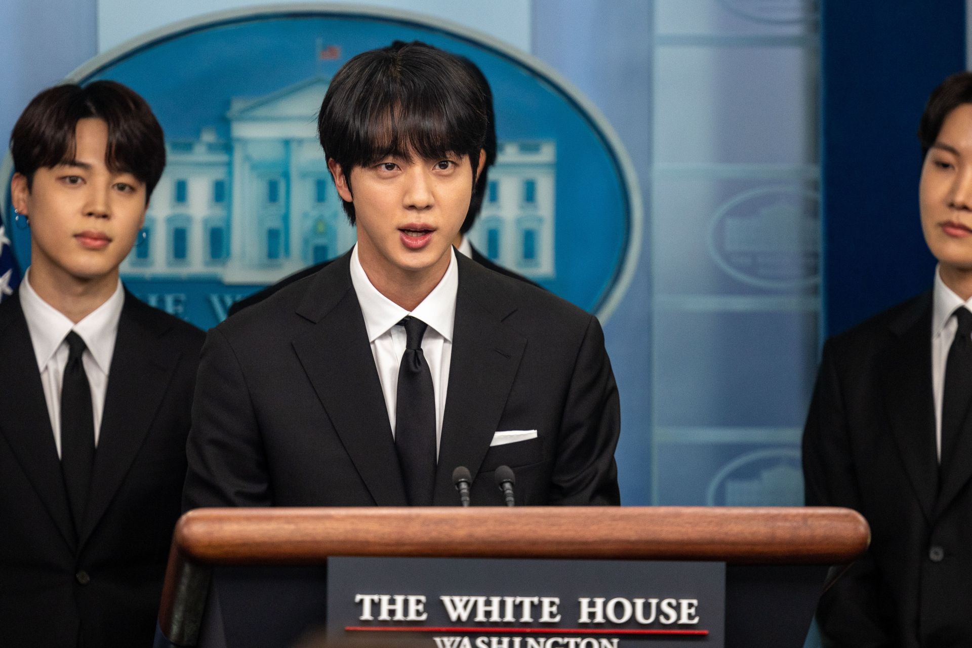 Ki Seokjin, aka Jin of BTS, speaks at a White House press briefing. (Image via Getty)