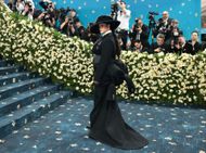 Rihanna in a gray and black pinstripe suit at The 2025 Met Gala (Image via Getty)