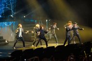 BTS in concert (Image via Getty)