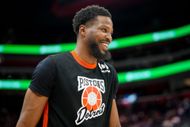 Malik Beasley looks on and smiles before the game against the San Antonio Spurs - Source: Getty