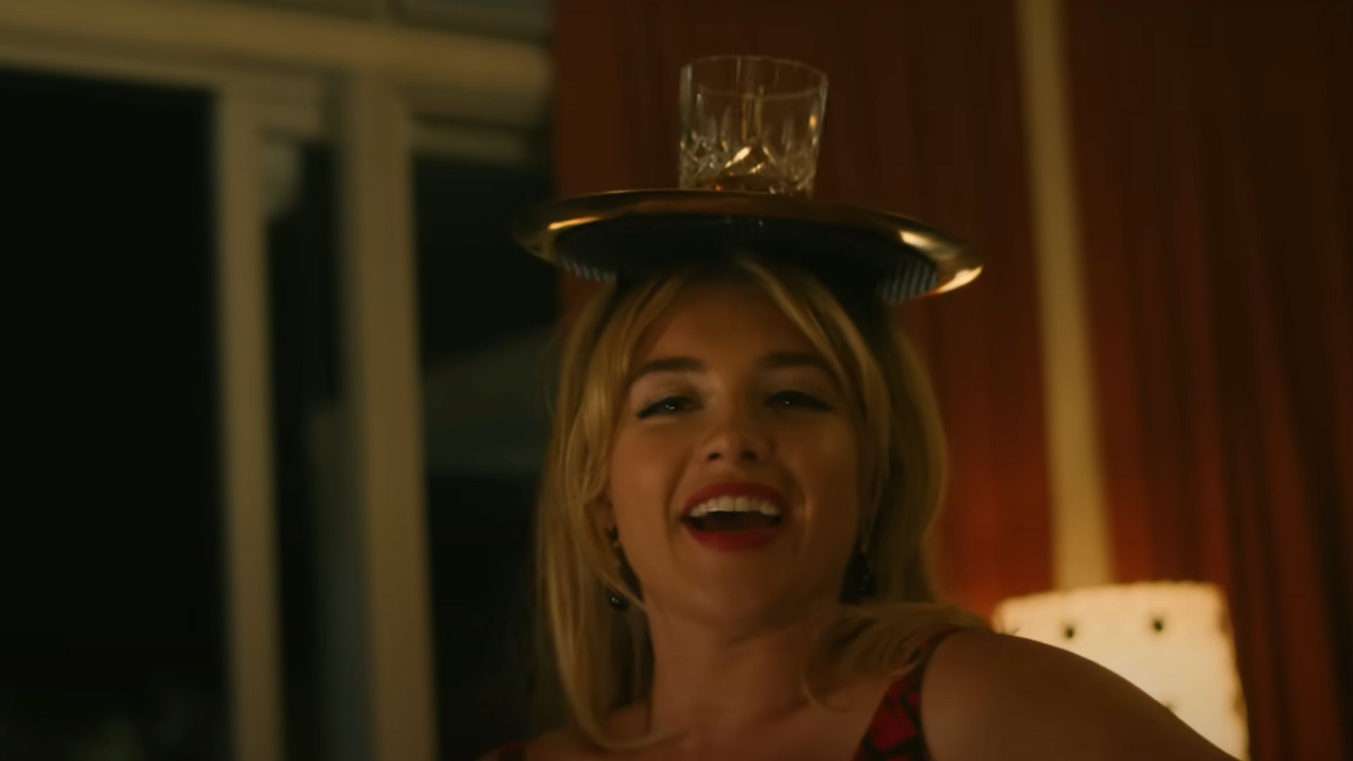 Alice balancing a glass on her head.