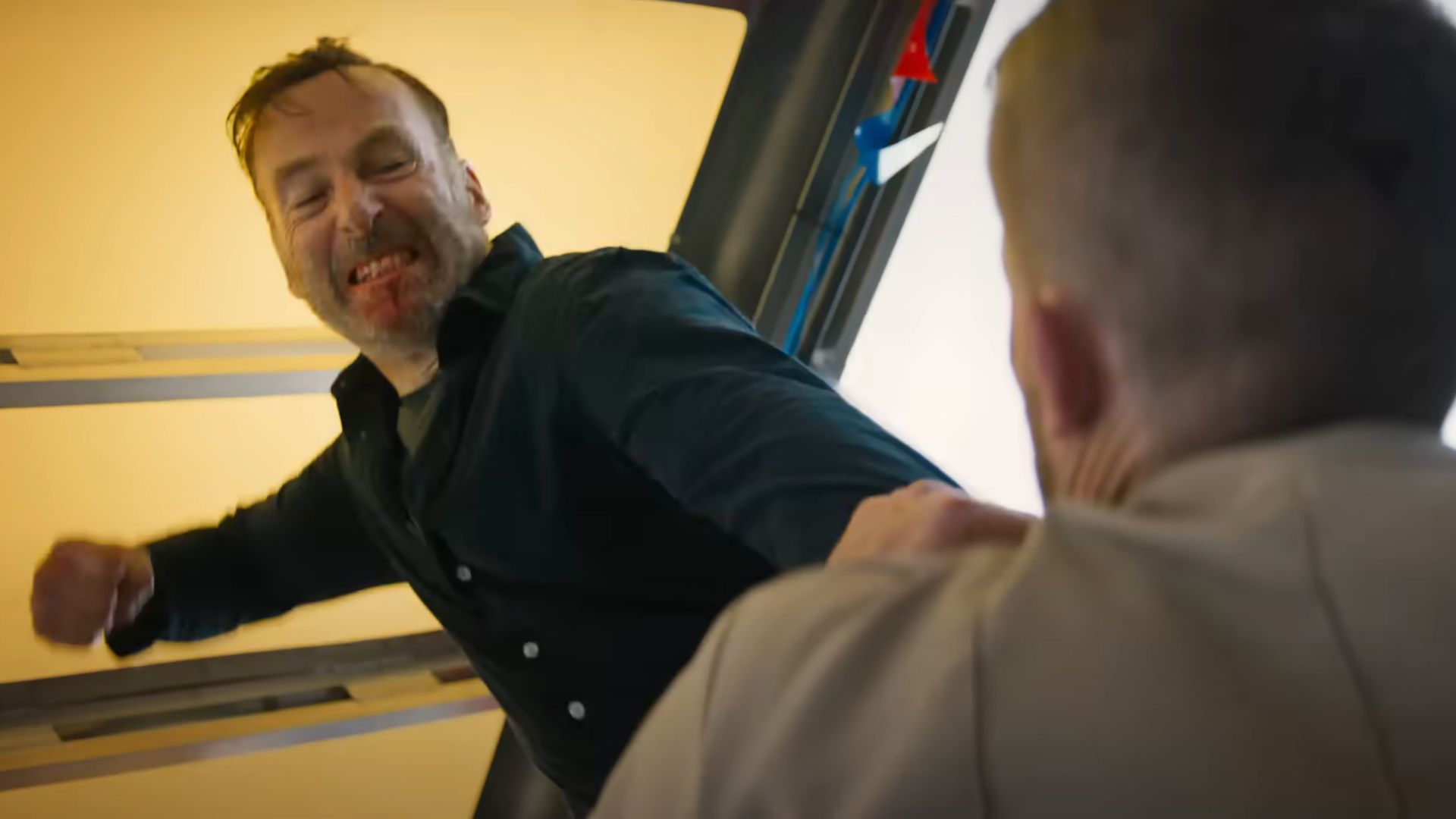 Hutch Mansell about to punch a guy while holding him down by his collar