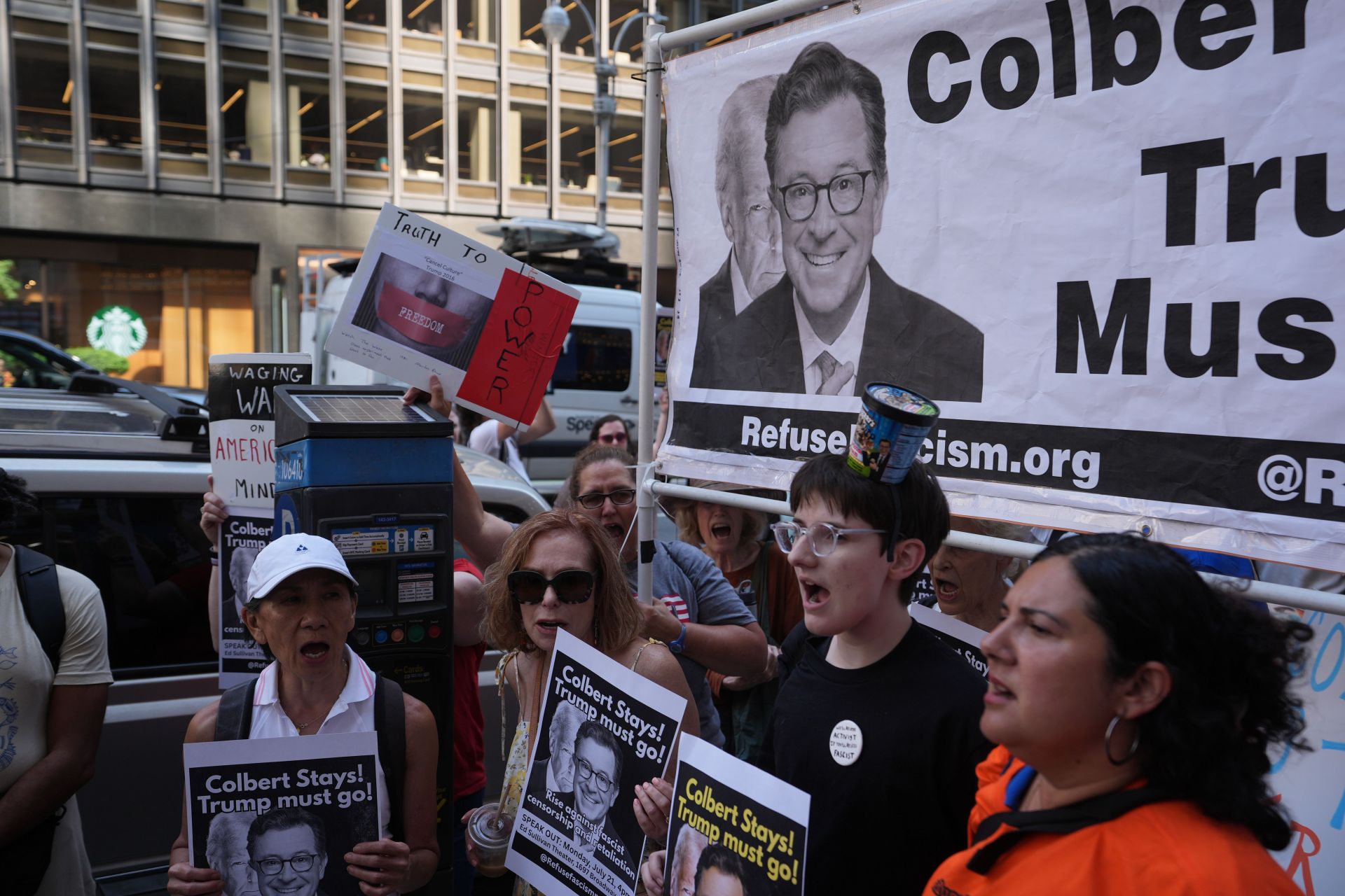 Anti-Trump protesters rally outside CBS Late Show Studio over Colbert Firing - Source: Getty
