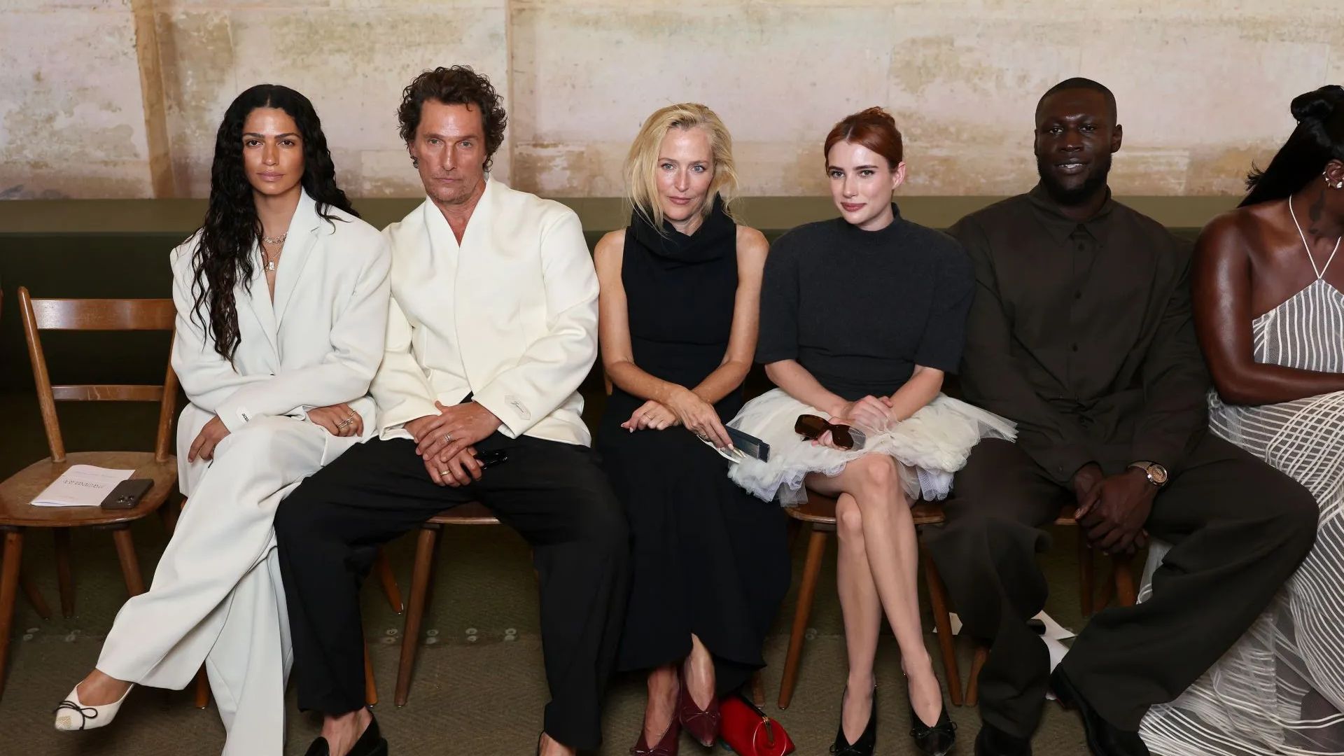 From Left to Right: Camila Alves McConaughey, Matthew McConaughey, Gillian Anderson, Emma Roberts and Stormzy attend the Jacquemus Menswear Spring/Summer 2026 (Image via Getty)