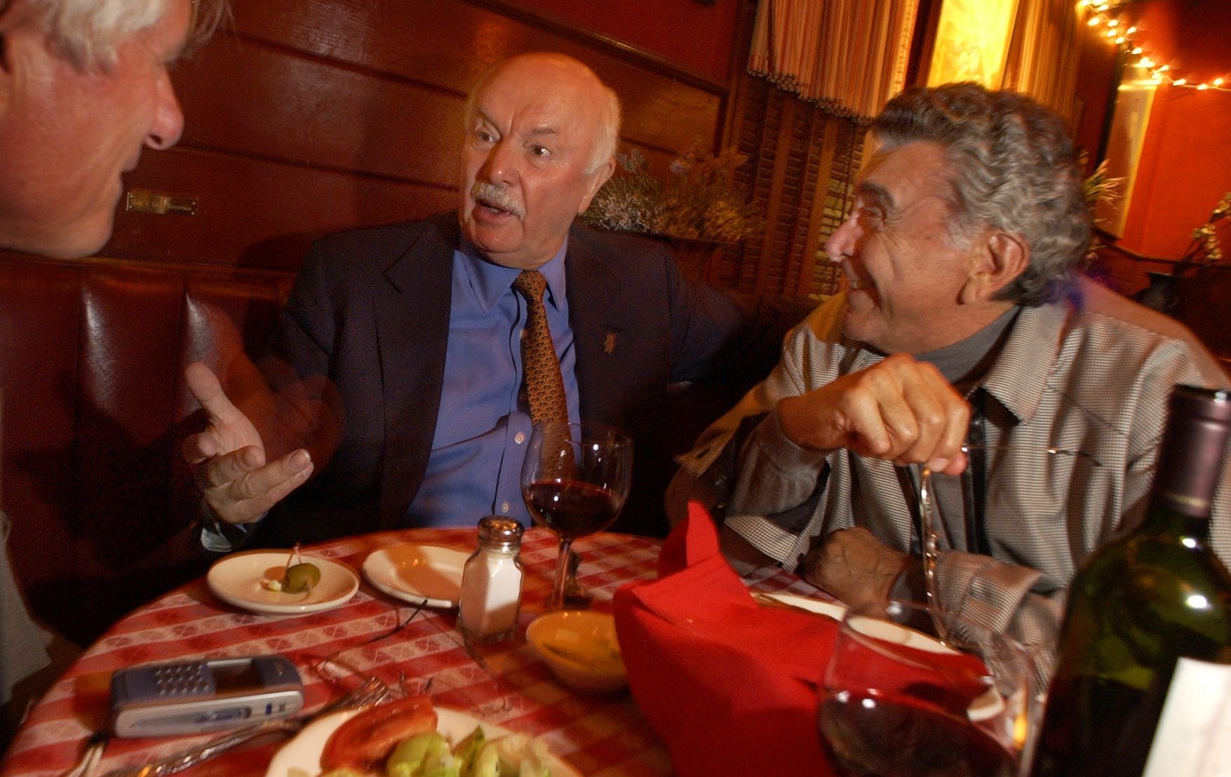 Dan Tana, center, shares a laugh with a couple of his patrons at his restaurant, Dan Tana&#039;s, Tuesday - (Image via Getty)