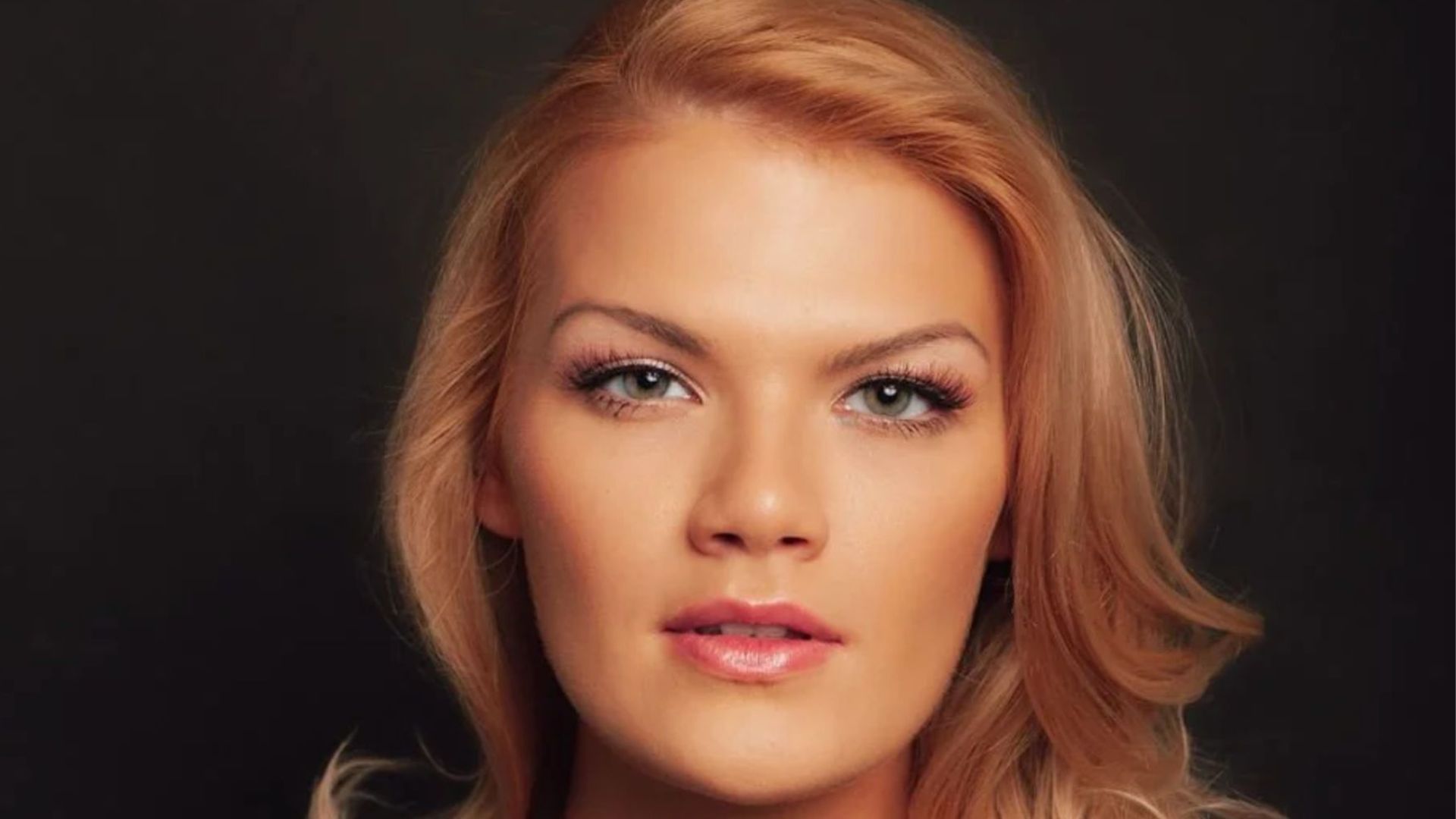 Cassie Donegan poses for photoshoot. Image featured on the landing page of her official wedbsite.