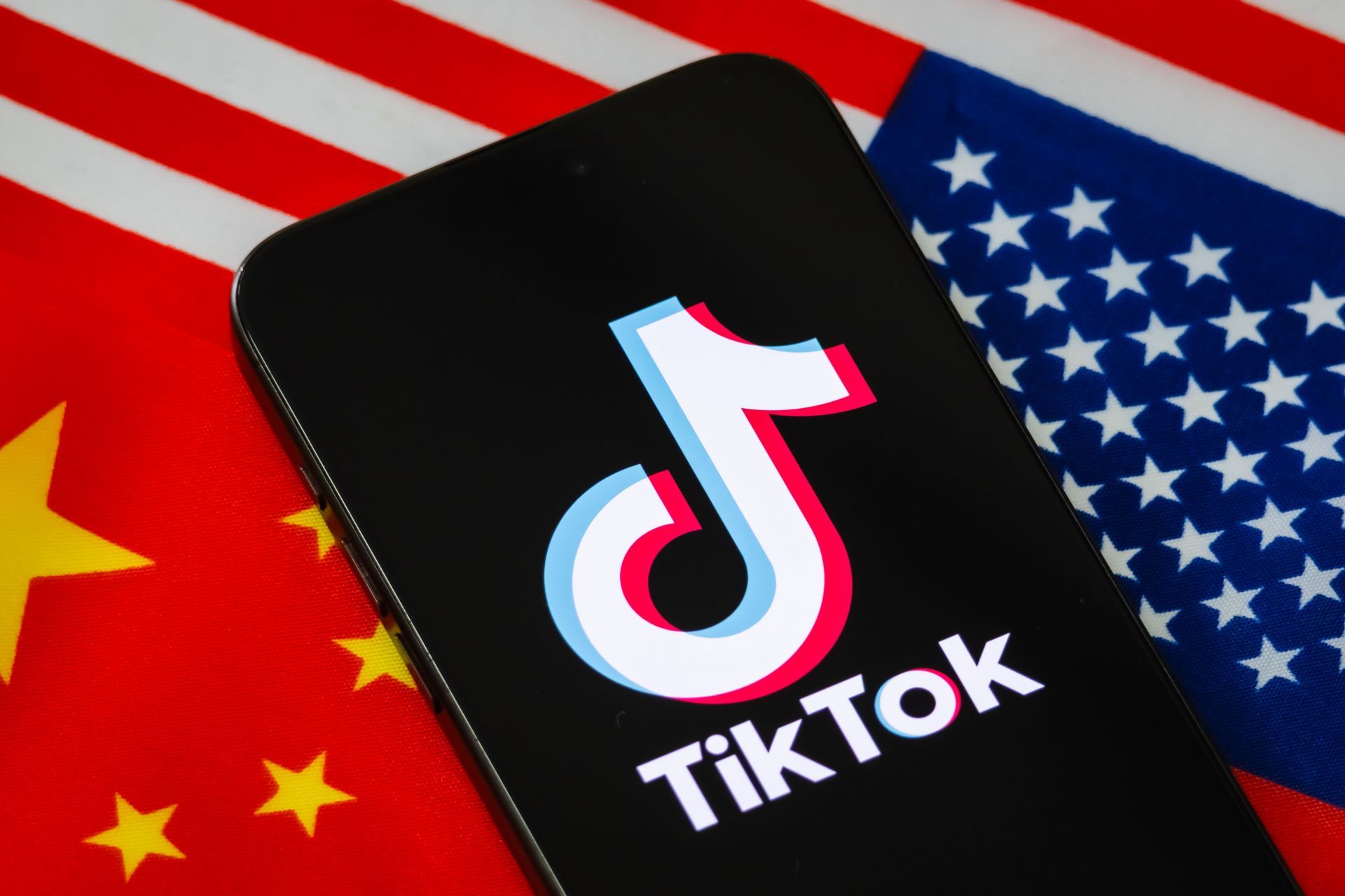 TikTok Logo Displayed On Smartphone Against Chinese And U.S. Flags - Source: Getty
