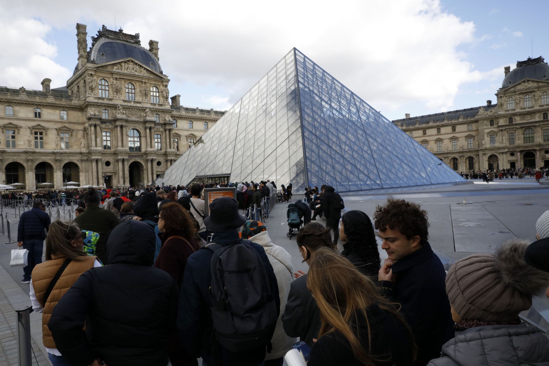 Crowds gather outside the Louvre Museum after Arrests Made In Jewelry Heist Investigation. Image via Getty.