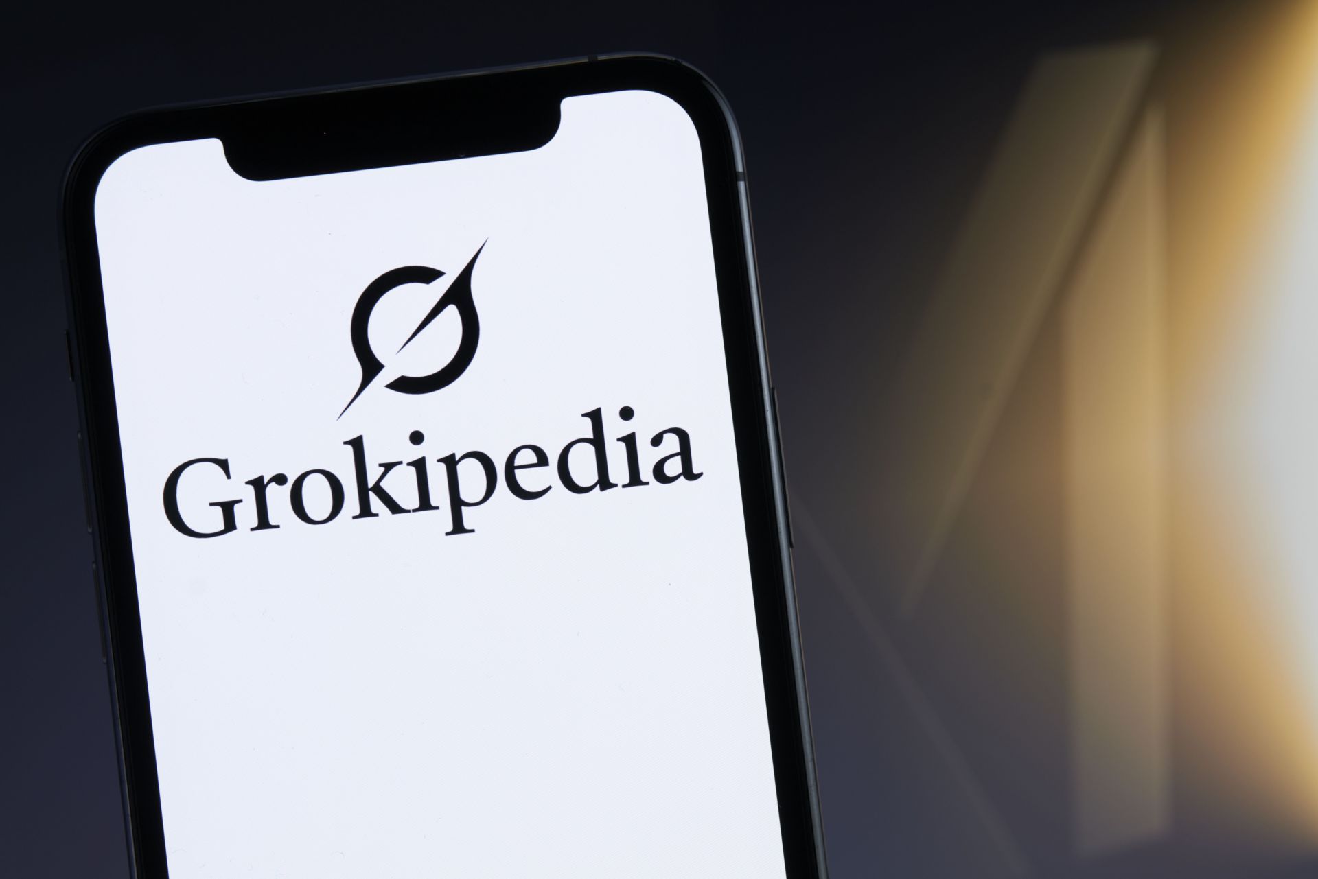 Grokipedia Logo Displayed On Smartphone Over Computer Keyboard - Source: Getty