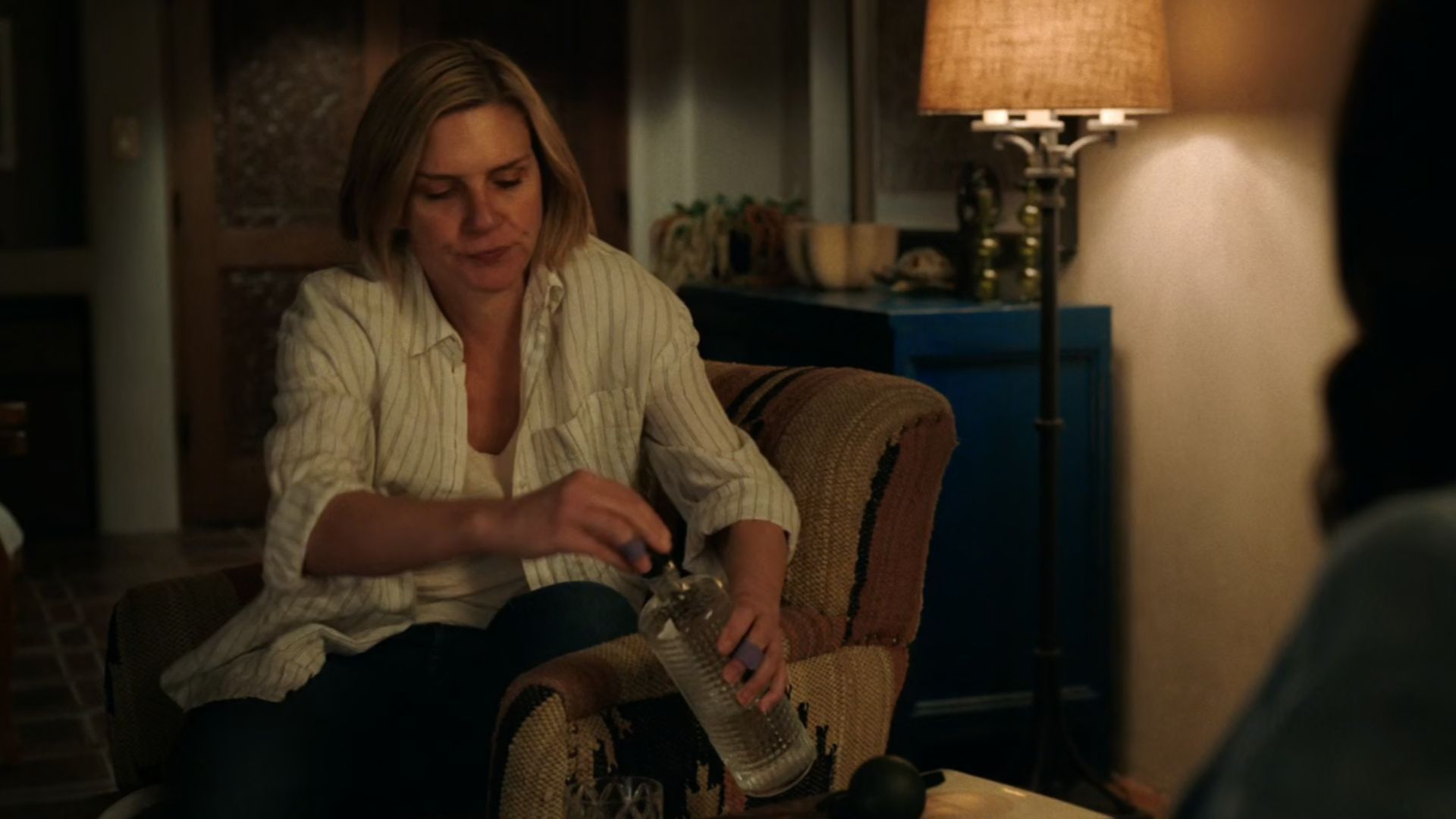 Carol (Rhea Seehorn) opens a bottle