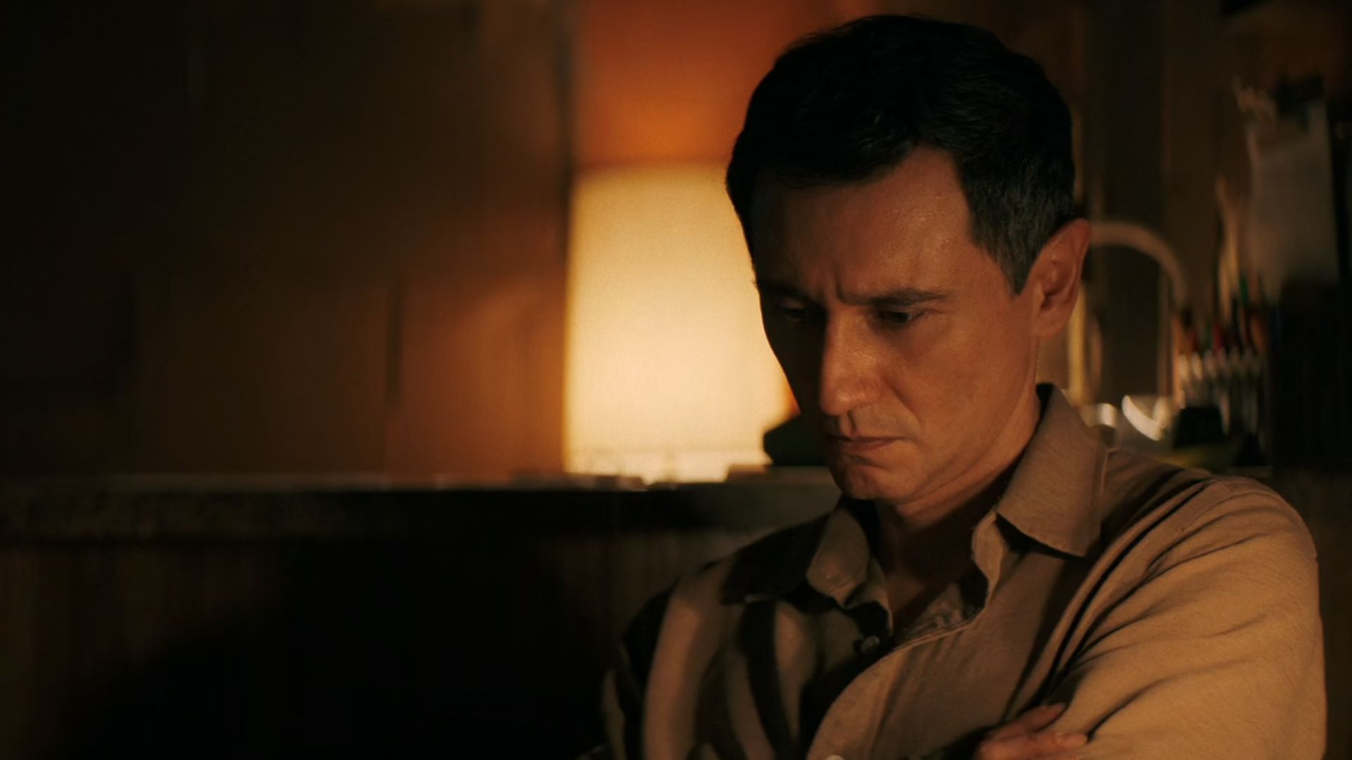 Manousos sits alone in his home