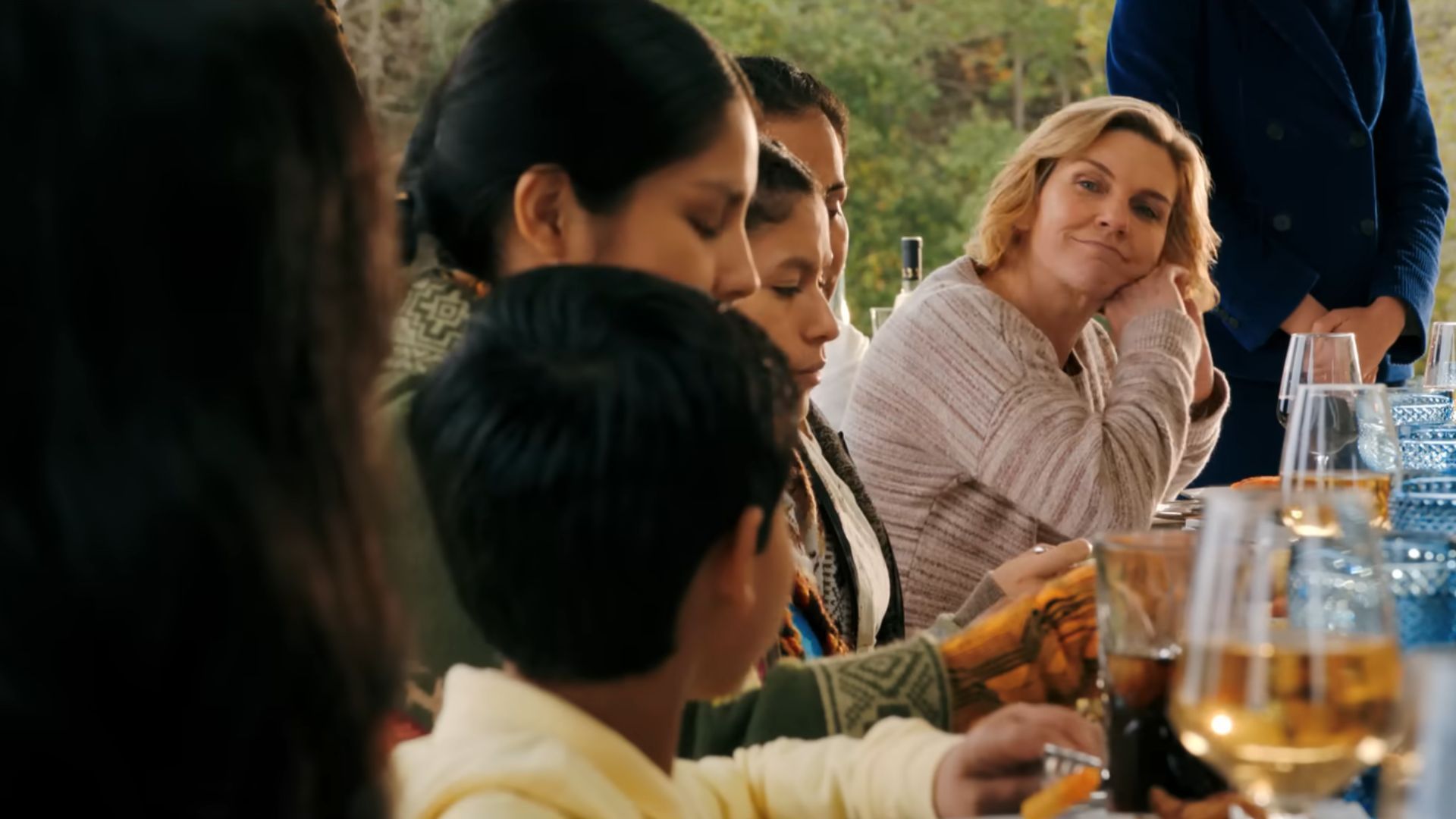 Carol (Rhea Seehorn) smiles and watches a kid while smiling