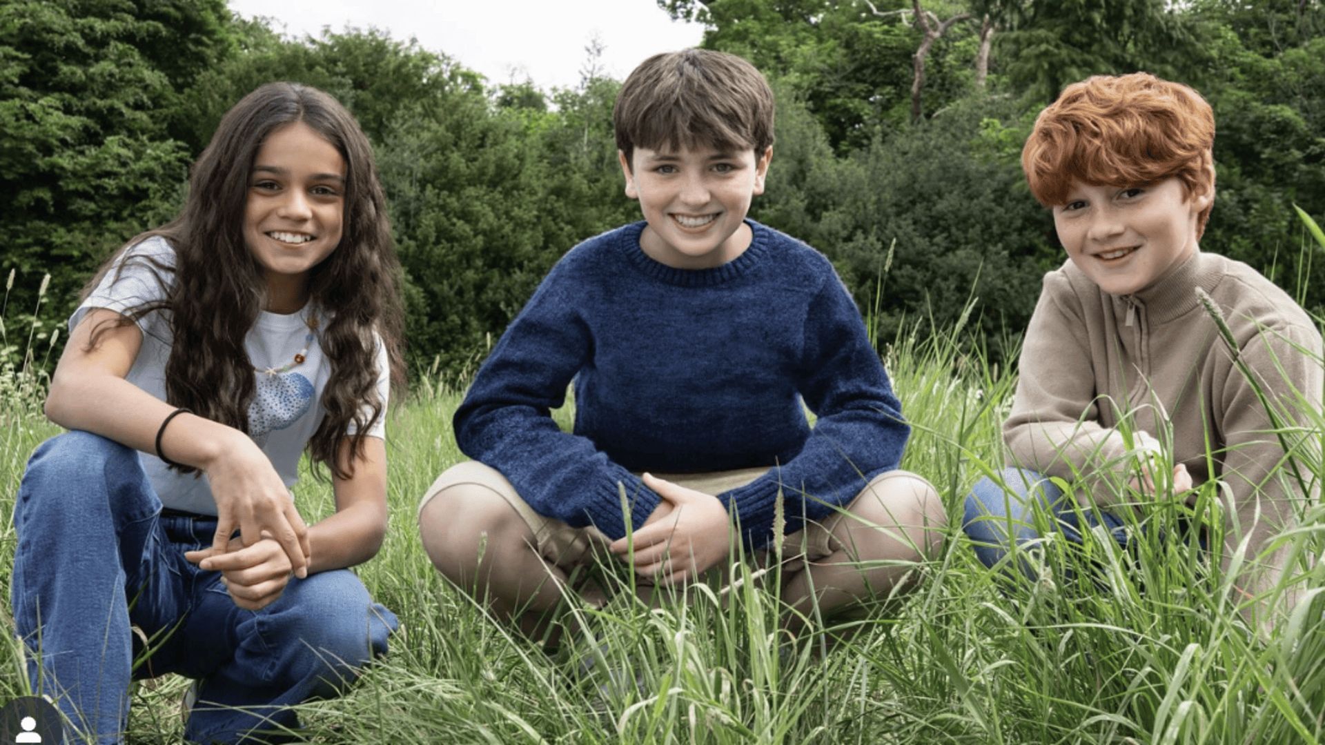 HBO Harry Potter cast Dominic McLaughlin, Alastair Stout and Arabella Stanton posing outdoor in a grassy 