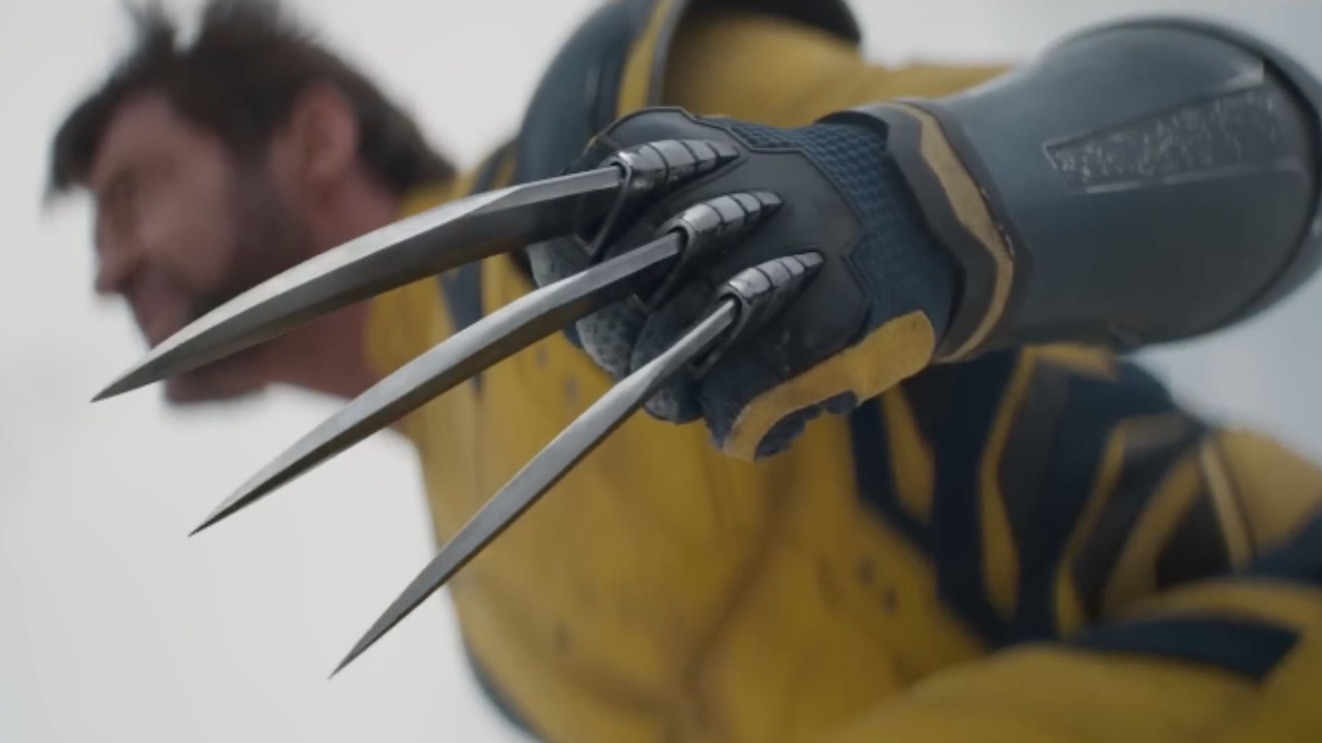 This is a still of Hugh Jackman as Wolverine in Deadpool &amp; Wolverine, which showcases his cases in the foreground and his face in the background