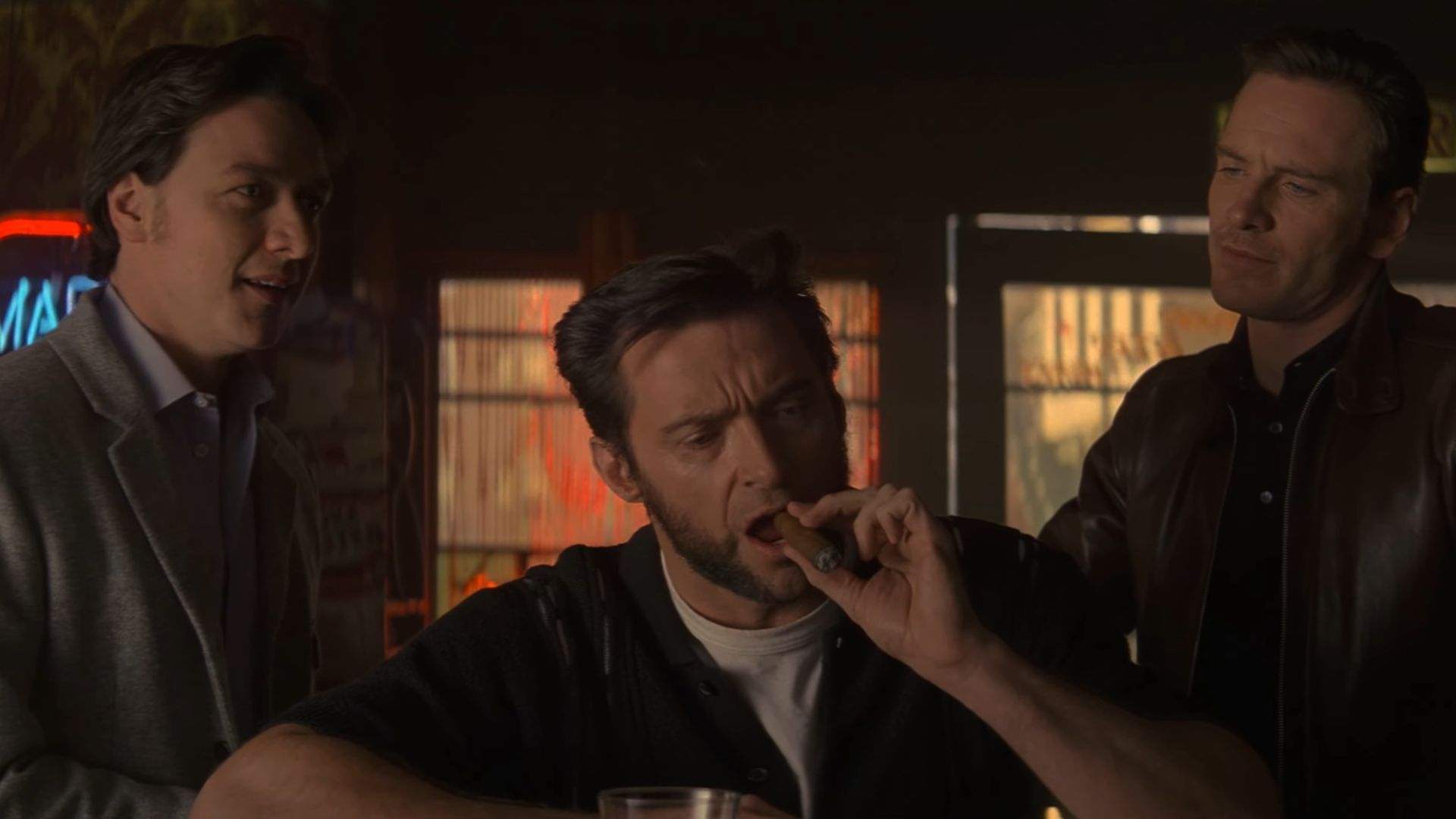Young Professor X and Magneto trying to recruit Wolverine. who is sitting in a bar