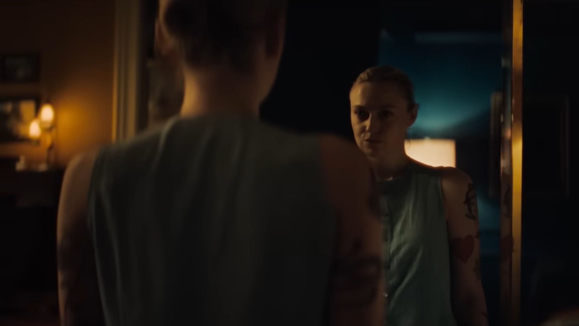 A woman staring her image in the mirror