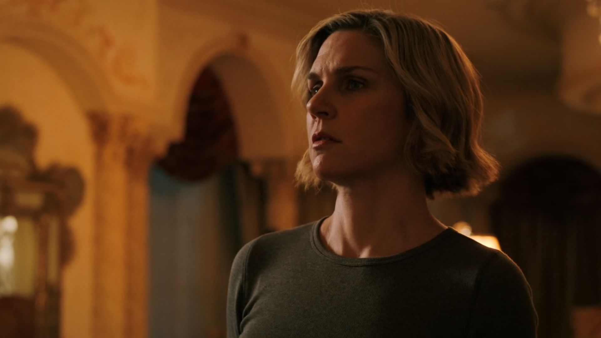 A close up of Carol (Rhea Seehorn) standing and talking to someone