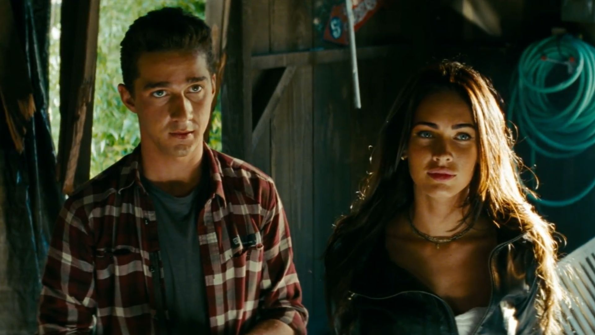 Sam (Shia LaBeouf) and Mikaela (Megan Fox) stands together in a garage