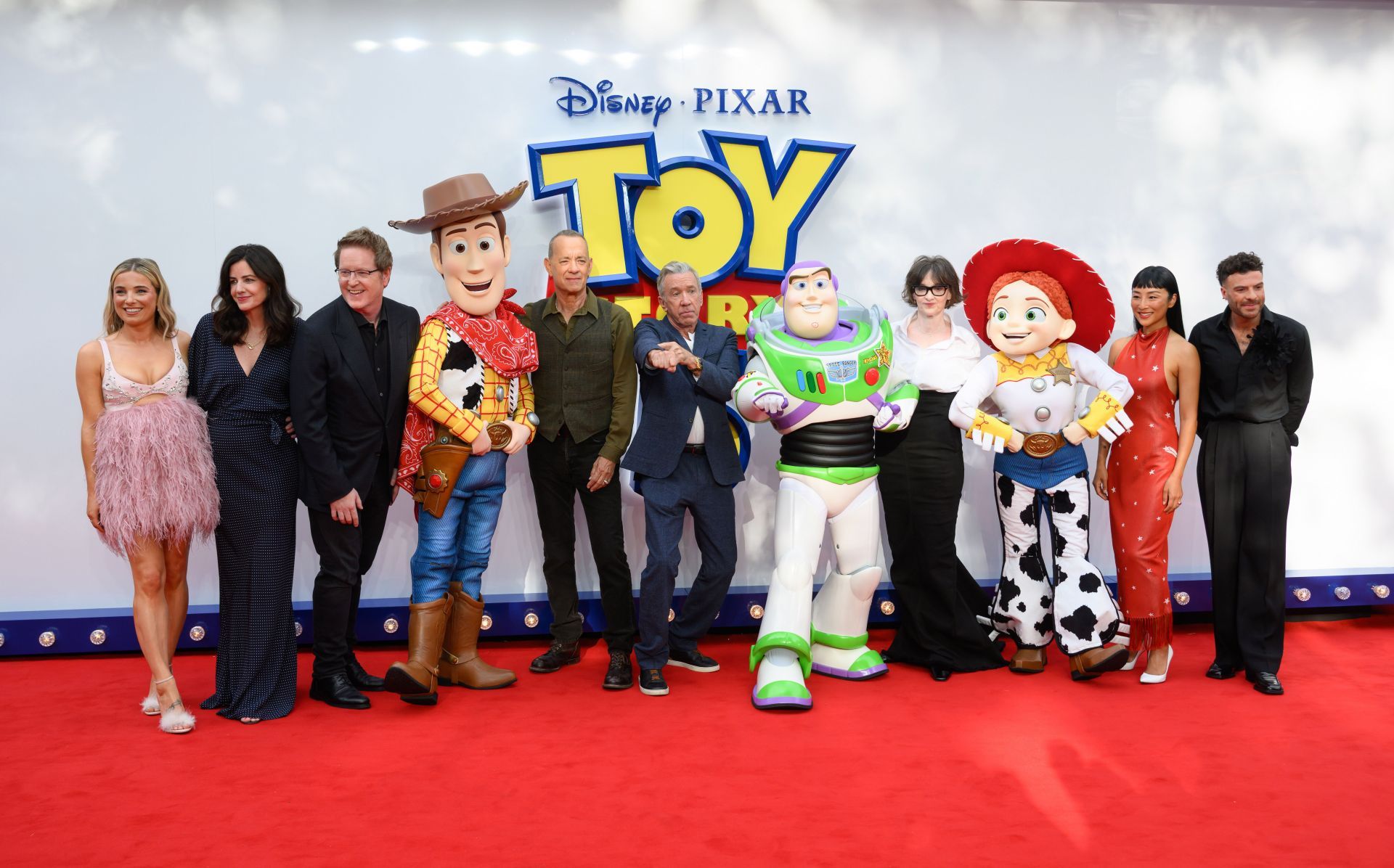 (L-R) Sian Welby, Lindsey Collins, Andrew Stanton, 'Woody', Tom Hanks, Tim Allen, 'Buzz Lightyear', Joan Cusack, 'Jessie', Greta Lee and Jordan North attend the "Toy Story 5" UK launch event at Odeon Luxe Leicester Square on May 28, 2026 in London, England - Source: Getty