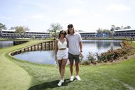 Trevor Lawrence and his wife Marissa Mowry smile for a photo near the 17th green during the second round of THE PLAYERS Championship at Stadium Course at TPC Sawgrass on March 15, 2024 in Ponte Vedra Beach, Florida - Source: Getty