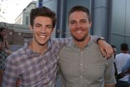 Grant Gustin of "The Flash" and Stephen Amell of "Arrow" attend Warner Bros. Television's Comic-Con cocktail media mixer at the Hard Rock Hotel's FLOAT Rooftop Bar on July 25, 2014 in San Diego, California - Source: Getty