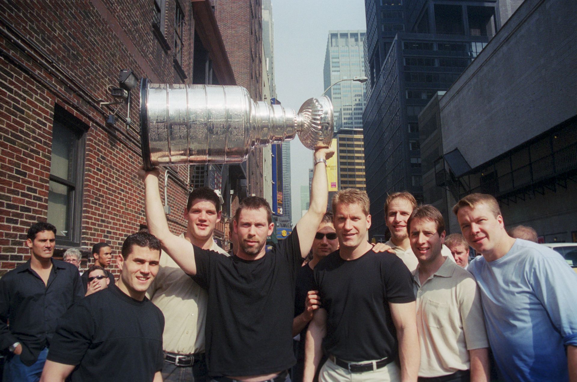 The New Jersey Devil's Hockey Team with the Stanley Cup, 1995. MVP Claude Lemieux left of the man holding the cup. They are being interviewed on the Letterman Show; 1995; New York - Source: Getty