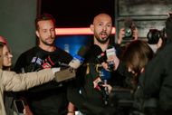 Andrew Tate and his brother Tristan Tate talk to the media outside their residence on March 23, 2025 in Bucharest, Romania - Source: Getty